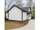 Newly renovated exterior showcases black accents, complementary landscaping, and fresh driveway at 1691 Flat Shoals Rd, Atlanta, GA 30316