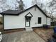 Side exterior of home with white siding and a well-maintained roof at 1691 Flat Shoals Rd, Atlanta, GA 30316