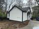 Side exterior view of home with white siding and a paved driveway at 1691 Flat Shoals Rd, Atlanta, GA 30316