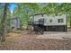 Back exterior view featuring a deck, wooded lot, and garage at 3333 Devaughn Ne Dr, Marietta, GA 30066