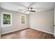 Bedroom featuring modern ceiling fan, two windows, and wood floors at 3333 Devaughn Ne Dr, Marietta, GA 30066