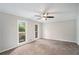 Large bedroom with ceiling fan, two windows, and carpet flooring at 3333 Devaughn Ne Dr, Marietta, GA 30066