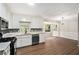 Modern kitchen featuring white cabinets, mosaic backsplash, stainless steel appliances, and wood floors at 3333 Devaughn Ne Dr, Marietta, GA 30066