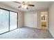 Bedroom with sliding glass door and closet, new gray carpet and neutral colors at 3436 Lake Monroe Rd, Douglasville, GA 30135
