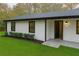 Side view of the home, showcasing the entrance, manicured lawn, and window details at 3436 Lake Monroe Rd, Douglasville, GA 30135