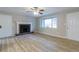 Cozy living room featuring a fireplace, hardwood floors, and natural light at 3436 Lake Monroe Rd, Douglasville, GA 30135