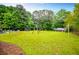 Large yard with mature trees, swing set, and patio at 4529 Lakeview Dr, Powder Springs, GA 30127