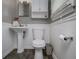 Cozy half-bath featuring neutral tones, pedestal sink, and modern fixtures at 4529 Lakeview Dr, Powder Springs, GA 30127