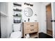 Well-lit bathroom featuring a modern vanity, open shelving and black accents against a bright white backdrop at 4529 Lakeview Dr, Powder Springs, GA 30127
