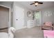 Charming bedroom featuring neutral walls, plush carpet, a modern ceiling fan and whimsical decor at 4529 Lakeview Dr, Powder Springs, GA 30127