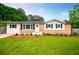 Beautiful single-story home with brick accents, a welcoming entrance, and a lush green lawn at 4529 Lakeview Dr, Powder Springs, GA 30127