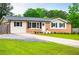 Charming ranch-style home featuring a brick facade, well-manicured lawn, and inviting curb appeal at 4529 Lakeview Dr, Powder Springs, GA 30127
