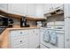 Charming kitchen featuring white cabinetry, light countertops, and essential appliances at 4529 Lakeview Dr, Powder Springs, GA 30127