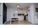 Eat-in kitchen featuring white cabinets, stainless steel appliances, and sleek laminate flooring at 4529 Lakeview Dr, Powder Springs, GA 30127