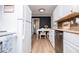 Eat-in kitchen with white cabinets, stainless steel appliances, and stylish laminate flooring at 4529 Lakeview Dr, Powder Springs, GA 30127