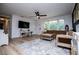 Bright living room with lots of natural light, sleek laminate flooring, and a modern ceiling fan at 4529 Lakeview Dr, Powder Springs, GA 30127