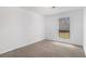 Clean bedroom with soft carpet, a window overlooking greenery, and a minimalist, bright atmosphere at 5444 Wylstream, Norcross, GA 30093