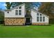 Striking home featuring a unique architectural design with stone accents and a well-manicured lawn at 5444 Wylstream, Norcross, GA 30093