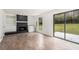 Bright living room with wood-look flooring, a stone fireplace, and a sliding glass door to the backyard at 5444 Wylstream, Norcross, GA 30093