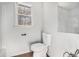 Bathroom with a toilet, window and faucet at 7935 Sweetwater Dr, Douglasville, GA 30135