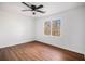 A well-lit bedroom featuring a ceiling fan, wood-look floors, and a window with natural light at 7935 Sweetwater Dr, Douglasville, GA 30135
