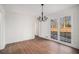 Dining room features a classic chandelier, large windows, and hardwood floors at 7935 Sweetwater Dr, Douglasville, GA 30135