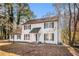 Charming two-story home with white siding, black shutters, and a well-manicured front yard at 7935 Sweetwater Dr, Douglasville, GA 30135