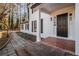 Close-up of front porch with black door, brick steps, and sidelight windows at 7935 Sweetwater Dr, Douglasville, GA 30135