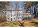 Bright two-story home with a large deck nestled among mature trees, offering privacy and outdoor enjoyment at 7935 Sweetwater Dr, Douglasville, GA 30135