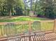 Backyard view from wood deck showing lush lawn and storage shed at 110 Orleans Blvd, Mcdonough, GA 30253