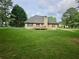 Large backyard with a well-kept lawn, fenced perimeter, and inviting home exterior at 110 Orleans Blvd, Mcdonough, GA 30253