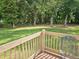 Enjoy the backyard view from the wood deck framed by tall trees at 110 Orleans Blvd, Mcdonough, GA 30253