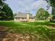 Expansive backyard view featuring a well-maintained lawn and a charming home exterior at 110 Orleans Blvd, Mcdonough, GA 30253