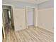 Bright bedroom features stylish wood-look flooring, beadboard accent, and spacious closet at 110 Orleans Blvd, Mcdonough, GA 30253