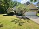 Charming single-Gathering home with a well-manicured lawn, landscaping, and attached two-car garage at 110 Orleans Blvd, Mcdonough, GA 30253