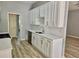 Modern kitchen boasts new white cabinets, stainless appliances, stone countertops, and trendy backsplash at 110 Orleans Blvd, Mcdonough, GA 30253