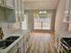 Bright kitchen with white cabinets, stone countertops, stainless appliances, and an adjacent dining area at 110 Orleans Blvd, Mcdonough, GA 30253