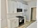 Updated kitchen featuring new white cabinets, stainless appliances, stone countertops, and modern backsplash at 110 Orleans Blvd, Mcdonough, GA 30253