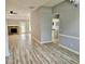 Open living area with hardwood style floors, a stone fireplace, and a view into the kitchen at 110 Orleans Blvd, Mcdonough, GA 30253