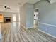 Spacious living room with attractive floors, a stone fireplace, and views into the kitchen at 110 Orleans Blvd, Mcdonough, GA 30253