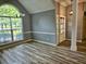 Open-concept living room featuring stylish flooring, trim, and a large window for lots of natural light at 110 Orleans Blvd, Mcdonough, GA 30253