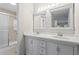 Bathroom featuring dual sinks, vanity, and a glass-enclosed shower, offering a clean and modern design at 1214 Lake Pointe Cir, Roswell, GA 30075