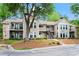 Charming multi-Gathering building featuring beige siding, stone accents, balconies, and scenic greenery at 1214 Lake Pointe Cir, Roswell, GA 30075