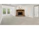 Spacious, bright living room featuring a stone fireplace, complemented by ample natural light from surrounding windows at 1214 Lake Pointe Cir, Roswell, GA 30075