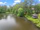 Picturesque pond with a gazebo, offering a tranquil and scenic view from the property at 1214 Lake Pointe Cir, Roswell, GA 30075