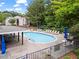 Community pool surrounded by lounge chairs and tables, perfect for relaxation at 1214 Lake Pointe Cir, Roswell, GA 30075