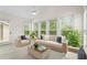 Cozy sunroom filled with natural light, perfect for relaxation with comfortable seating and nature views at 1214 Lake Pointe Cir, Roswell, GA 30075