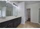 Bathroom with double sink vanity, decorative lighting, a large mirror, and tiled floor at 233 Yorkshire Ln, Villa Rica, GA 30180