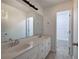 Bathroom with a double vanity sink with a large mirror and neutral color palette at 233 Yorkshire Ln, Villa Rica, GA 30180