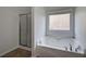 A luxurious bathroom features a standalone soaking tub and glass-enclosed shower at 233 Yorkshire Ln, Villa Rica, GA 30180